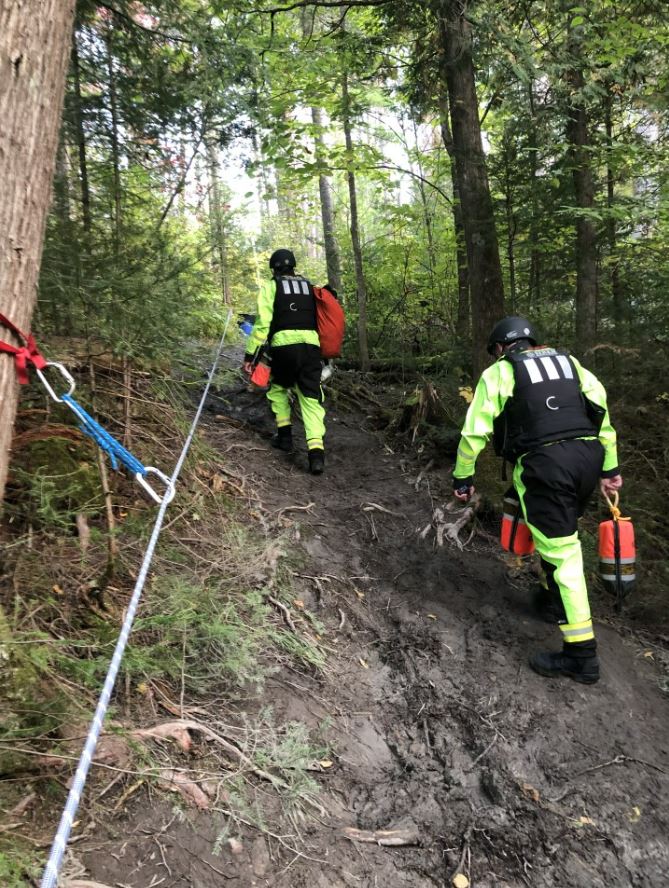 Siren Safety rescue team ascending a roped slope in the Northern Ontario bush